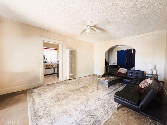 living room with ceiling fan and a textured ceiling