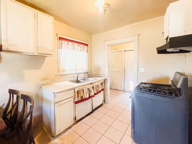 kitchen featuring ventilation hood, sink, light tile patterned floors, gas stove, and white cabinetry