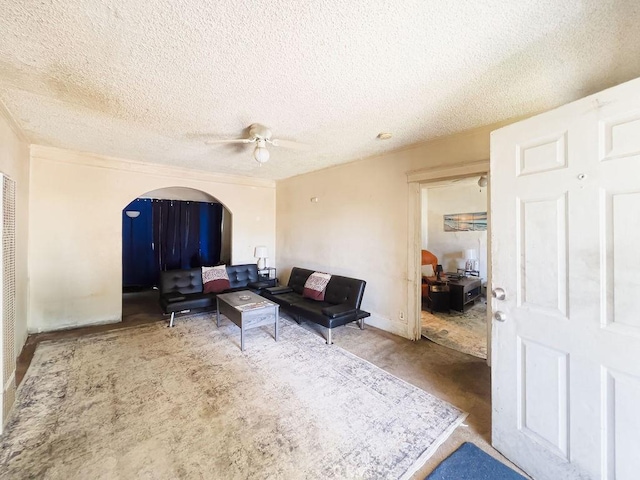 living room featuring ceiling fan and a textured ceiling