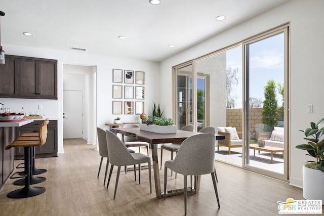 dining area with light hardwood / wood-style flooring and a wealth of natural light