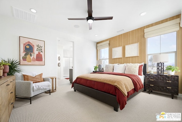 bedroom featuring ceiling fan, carpet floors, and ensuite bathroom