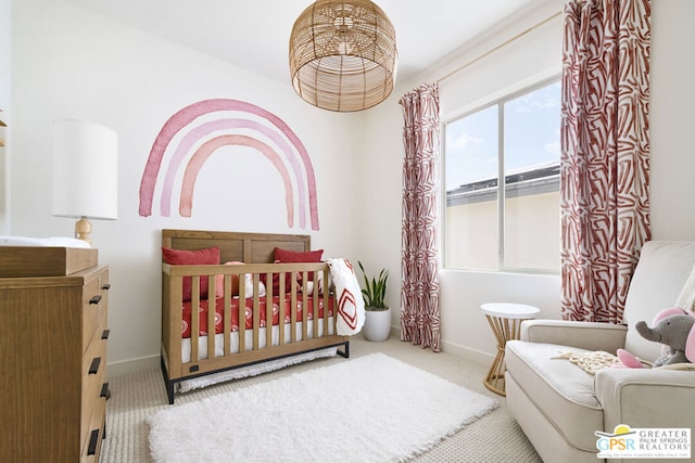 bedroom featuring light colored carpet and a crib