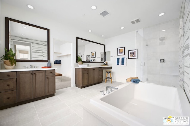 bathroom with tile patterned floors, vanity, and separate shower and tub