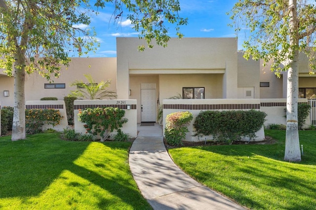 southwest-style home with a front lawn