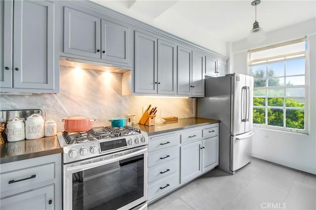 kitchen featuring gray cabinetry, stainless steel appliances, backsplash, decorative light fixtures, and light tile patterned floors