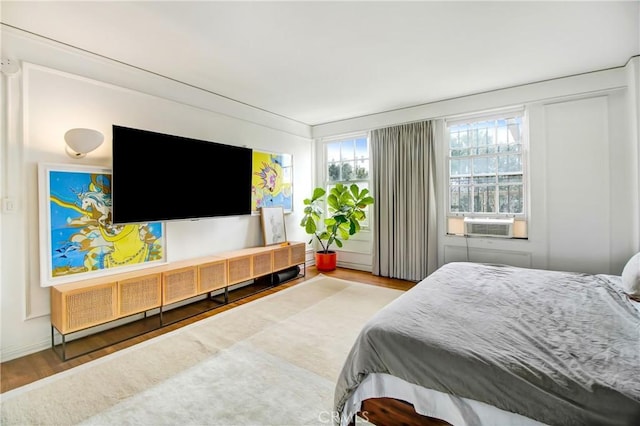 bedroom featuring cooling unit and hardwood / wood-style flooring