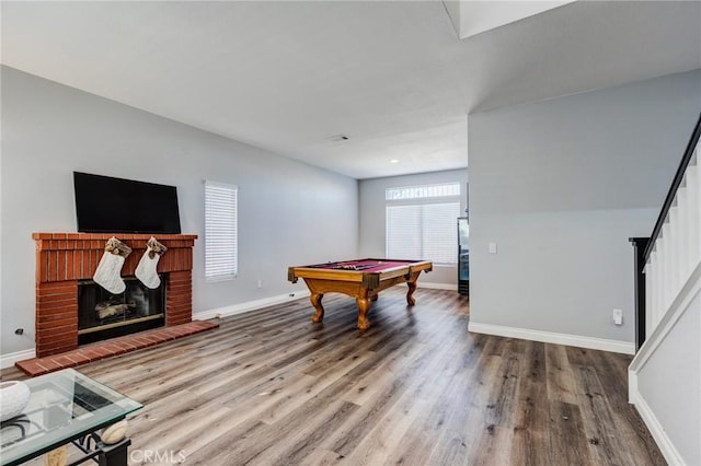 recreation room with hardwood / wood-style flooring, a fireplace, and billiards