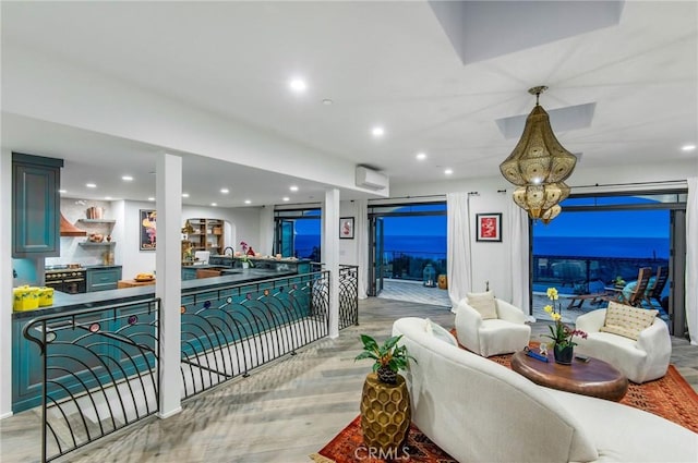 interior space with a wall mounted AC, light hardwood / wood-style flooring, and sink