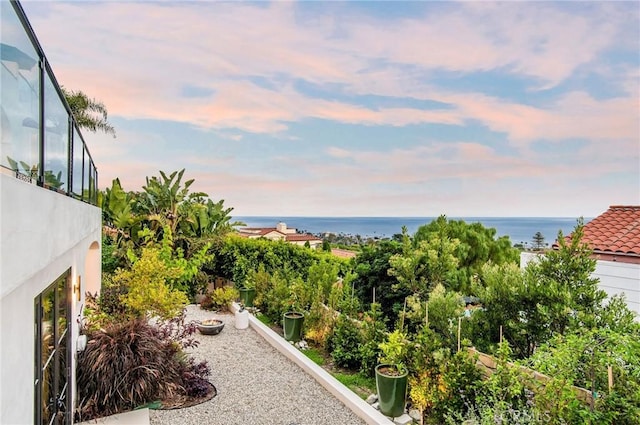 exterior space with a water view and a patio