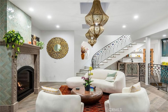 living room with light wood finished floors, stairs, and recessed lighting