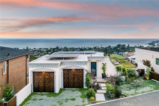 view of front of property with a water view