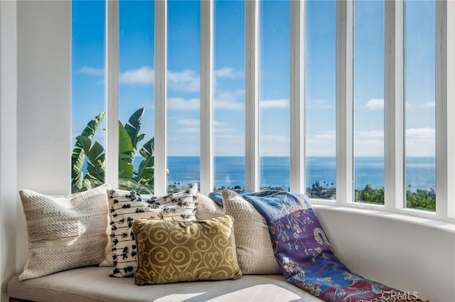 sunroom / solarium featuring a water view