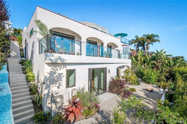 rear view of property featuring a balcony