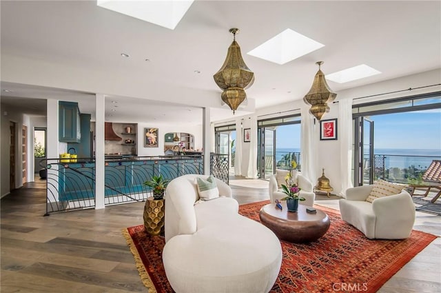 living room with wood finished floors and a skylight
