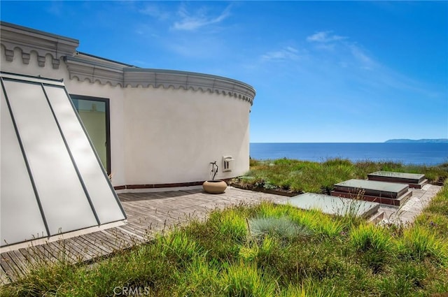 view of home's exterior featuring stucco siding and a water view