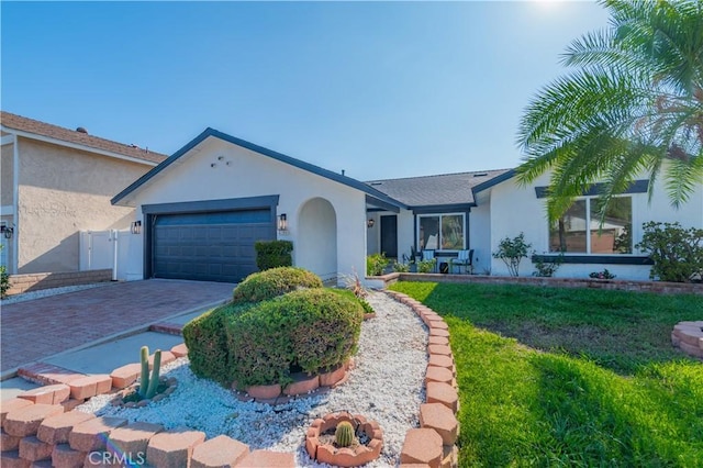 ranch-style house with a garage and a front yard