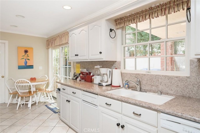 kitchen featuring white cabinets, dishwasher, and a healthy amount of sunlight