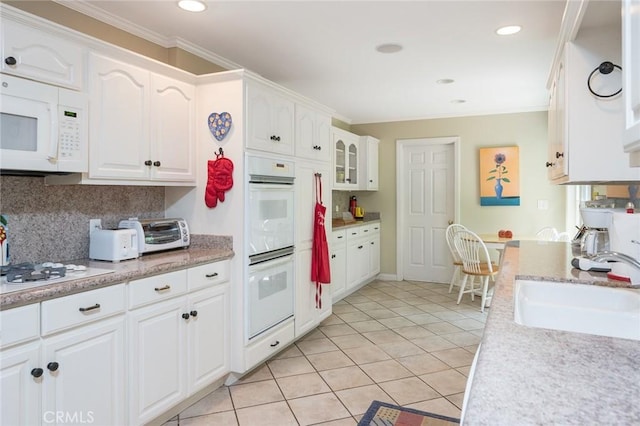 kitchen featuring sink, white cabinets, white appliances, and ornamental molding