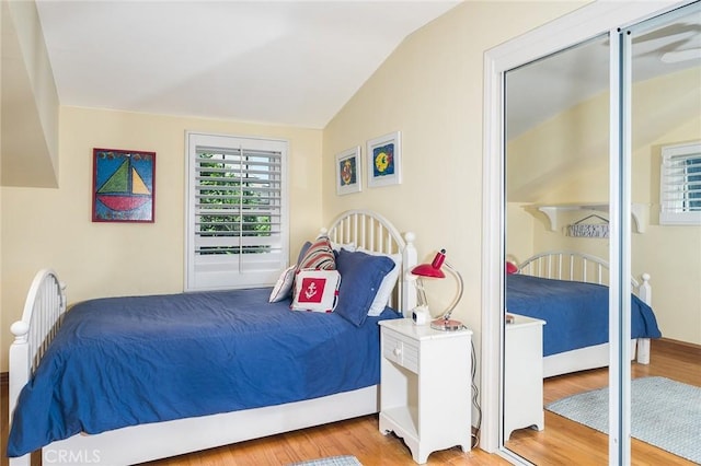 bedroom featuring hardwood / wood-style floors and vaulted ceiling