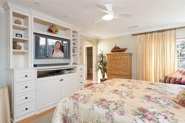 bedroom with crown molding, ceiling fan, and light wood-type flooring