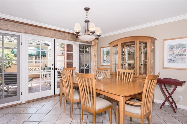 tiled dining space featuring crown molding and a chandelier