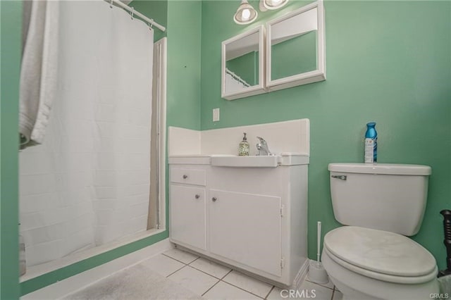 bathroom with toilet, vanity, tile patterned flooring, and curtained shower