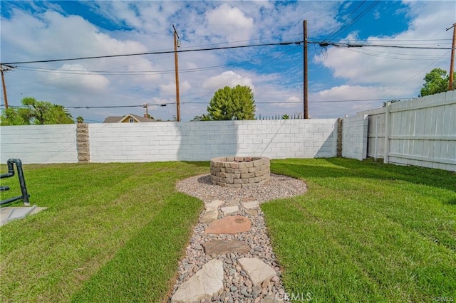 view of yard with an outdoor fire pit