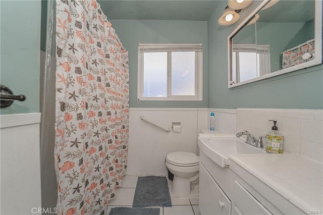 bathroom with toilet, tile patterned flooring, a shower with curtain, and vanity