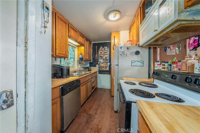 kitchen featuring exhaust hood, sink, stainless steel appliances, and wood-type flooring