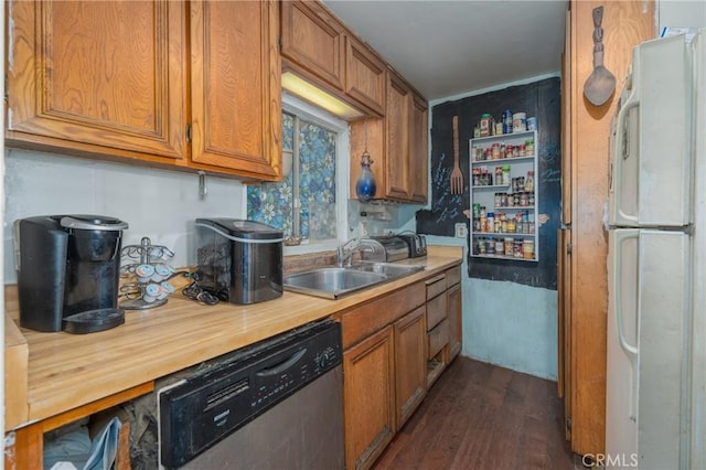 kitchen with sink, white fridge, stainless steel dishwasher, and dark hardwood / wood-style floors