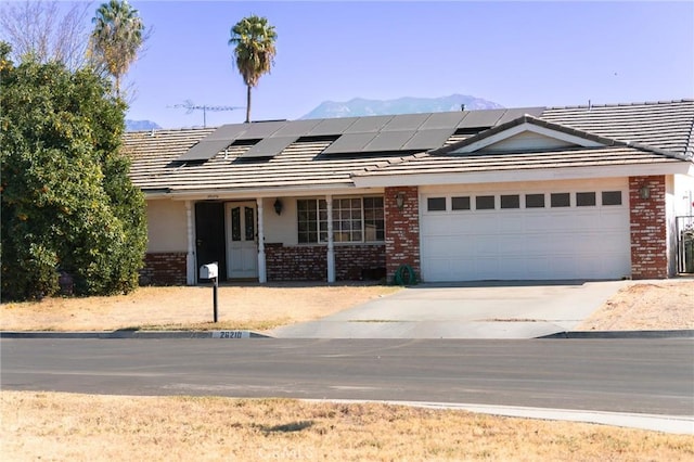 view of front of property with a mountain view and a garage