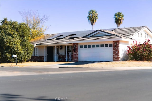 single story home featuring covered porch and a garage