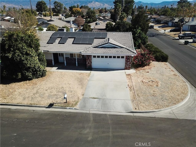 view of front of house featuring solar panels and a garage