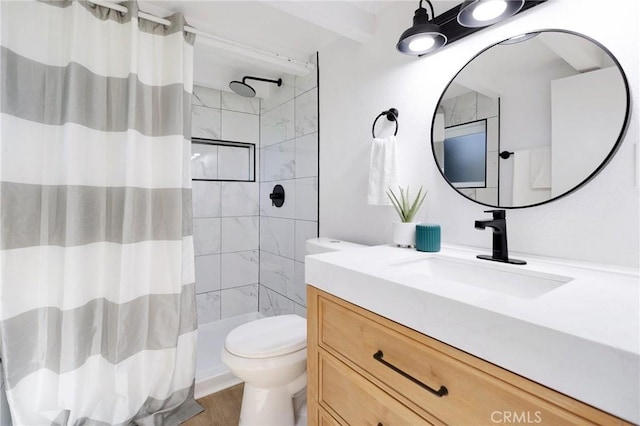 bathroom with curtained shower, hardwood / wood-style floors, vanity, and toilet