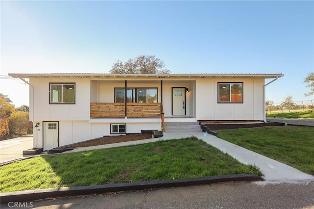 view of front of property with covered porch and a front lawn