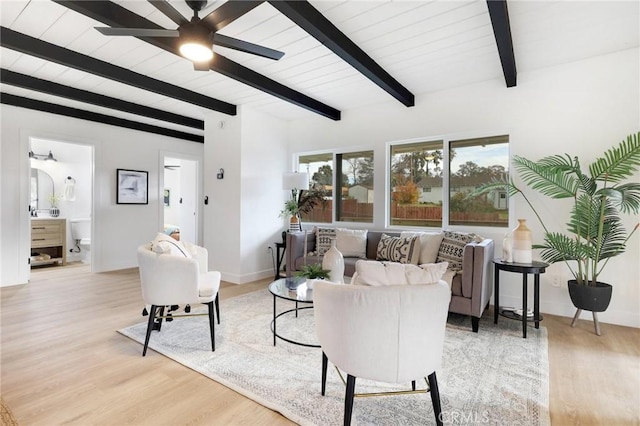 living room featuring beam ceiling, light hardwood / wood-style flooring, and ceiling fan