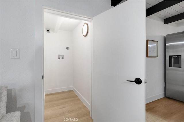 hallway with light hardwood / wood-style flooring and beamed ceiling