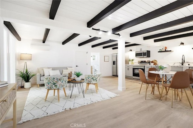 living room featuring light hardwood / wood-style floors and beam ceiling