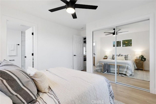 bedroom with light wood-type flooring, a closet, and ceiling fan