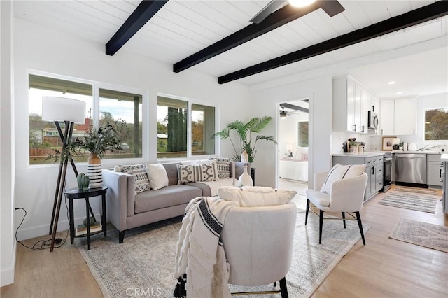 living room featuring beamed ceiling, wood ceiling, and light hardwood / wood-style flooring