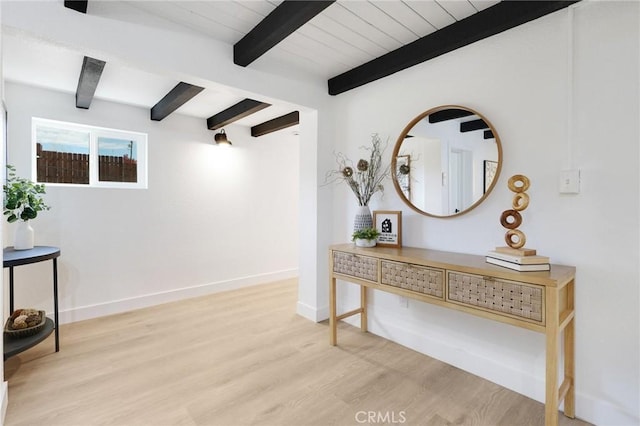 hallway with beamed ceiling and light hardwood / wood-style floors