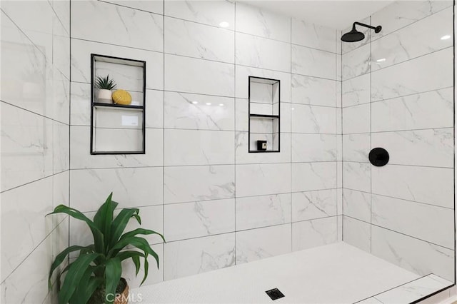 bathroom with tiled shower