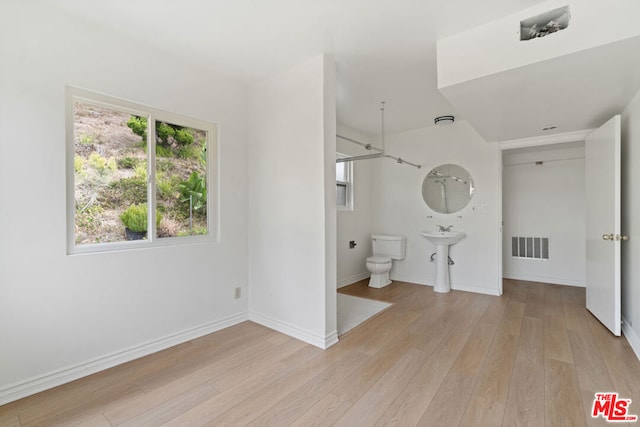 bathroom featuring hardwood / wood-style floors, toilet, and sink