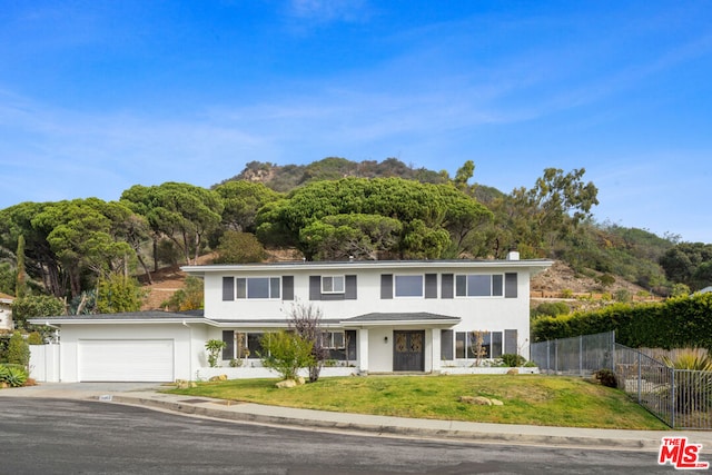 view of front of home featuring a garage and a front lawn