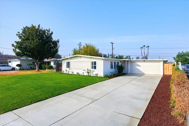 view of front of home featuring a garage and a front lawn