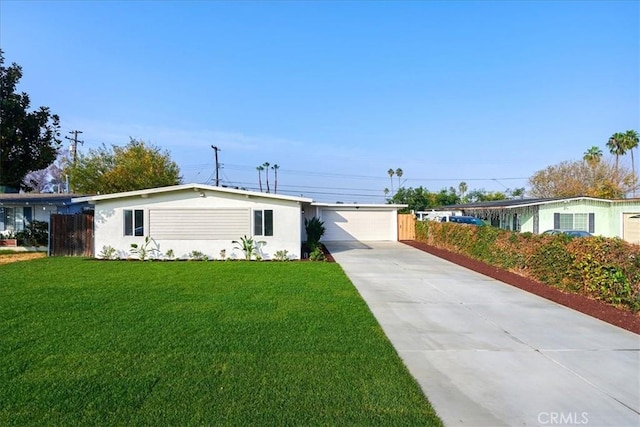 view of front of home with a front yard and a garage