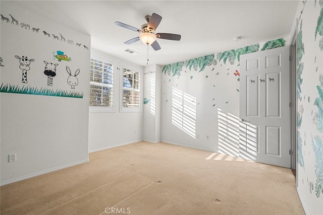 carpeted empty room with ceiling fan