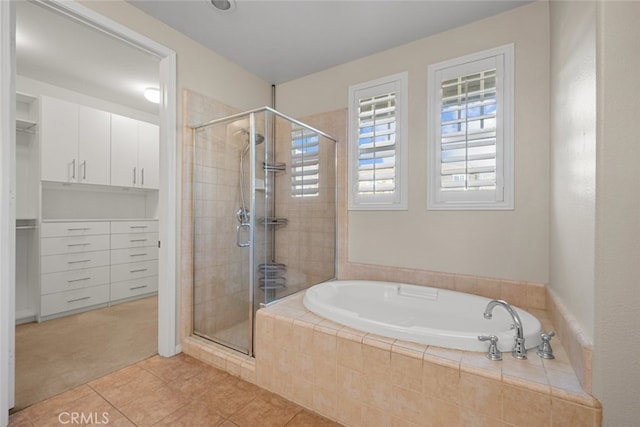 bathroom featuring tile patterned floors and shower with separate bathtub