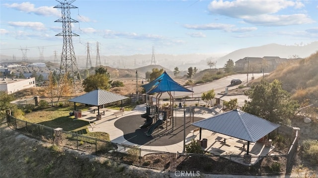 view of patio with a playground, a mountain view, and a gazebo