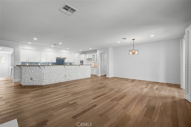 unfurnished living room with hardwood / wood-style floors